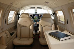 The interior of the Piper Malibu Mirage includes six adjustable leather seats refreshment accessories and a folding writing table. The PA46 Mirage is pressurized and airconditioned.